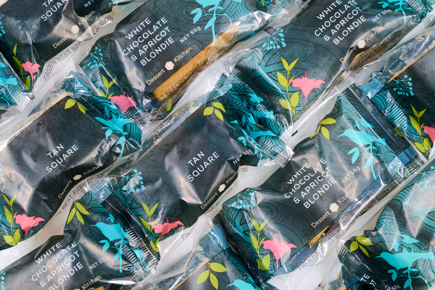 Close-up of chocolate bars in clear packaging with decorative designs. Dessert Kitchen Partnership Manufacturing